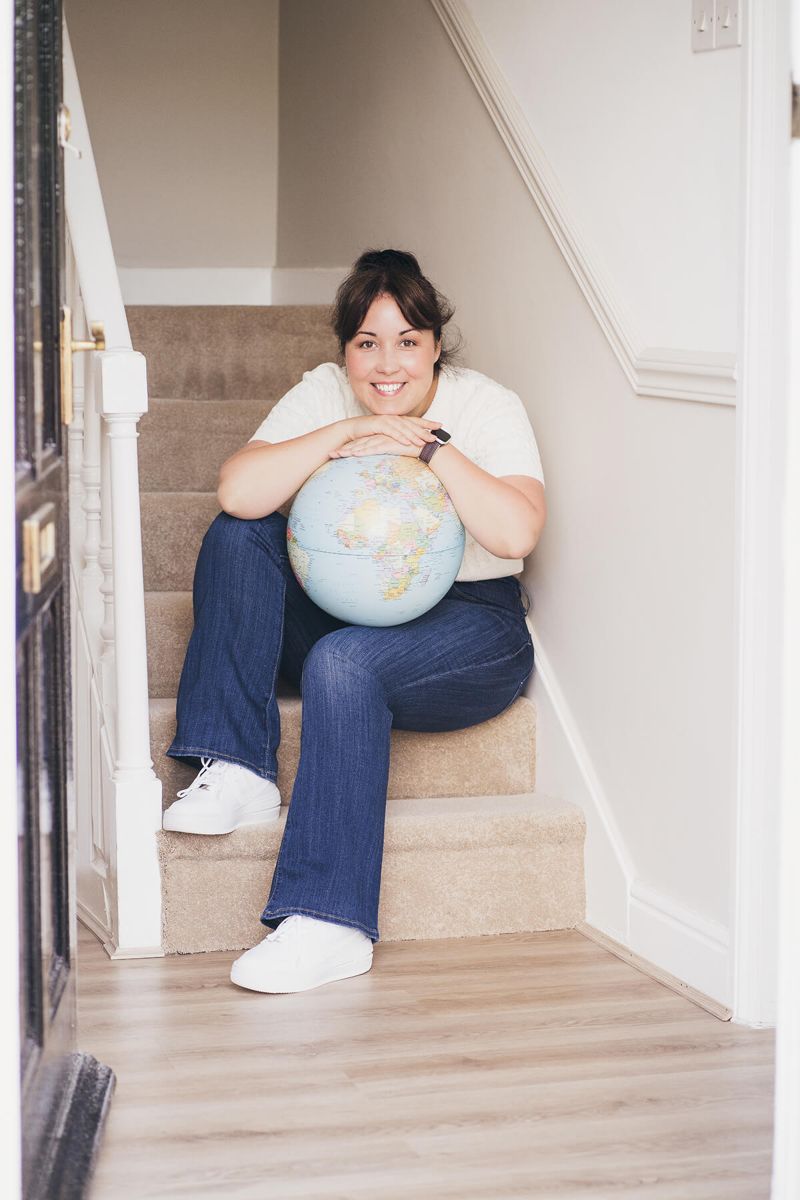 Aniko Rucz sitting with a globe